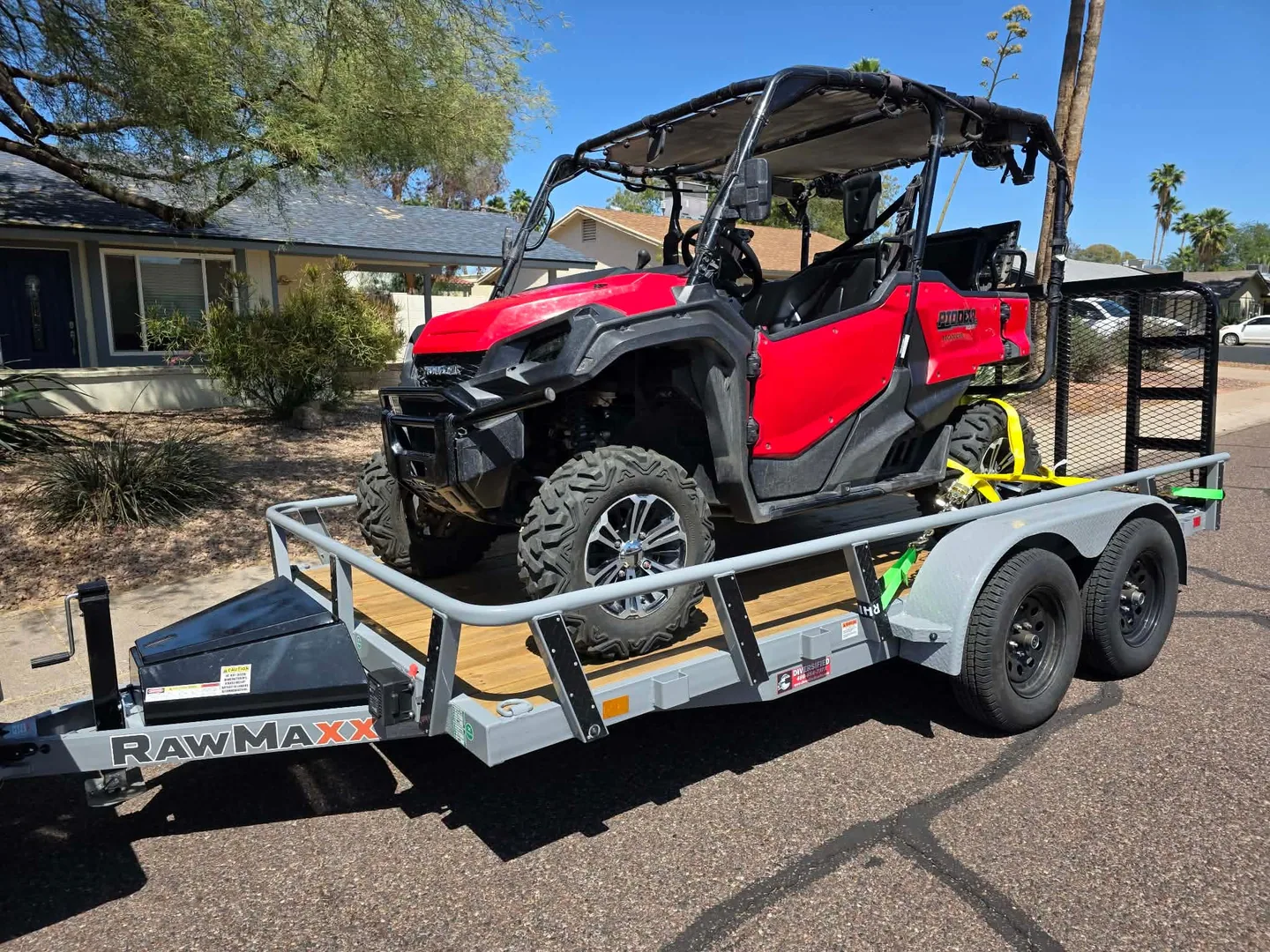 Customer photo: a Honda side-by-side loaded on the RawMaxx UTX utility trailer